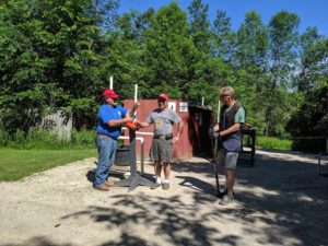 Three guys talking about their round.